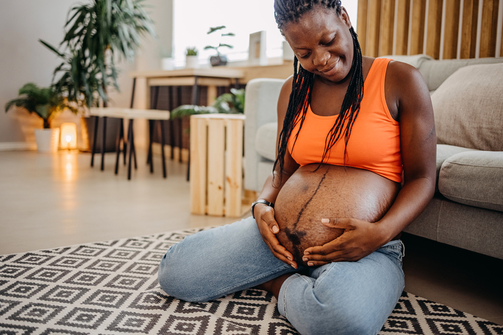 Pregnant woman touching her belly
