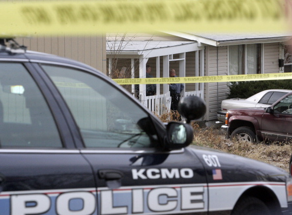Police tape marks the scene outside the residence where five