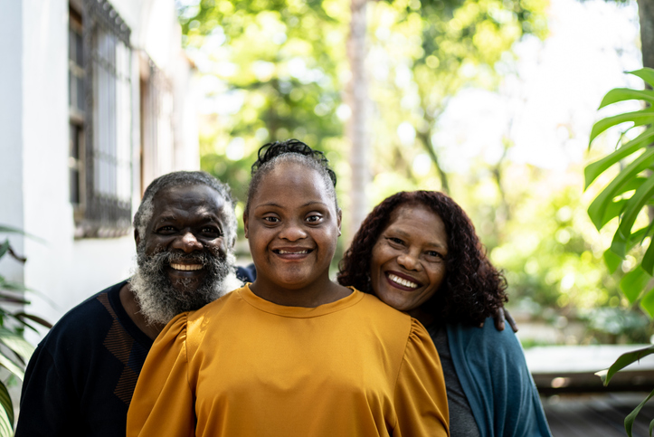 Portrait of a parents with their daughter with special needs at home