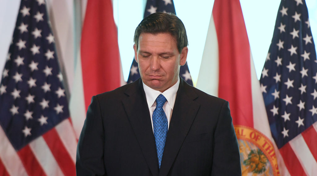Florida Gov. Ron DeSantis listens during a press conference...