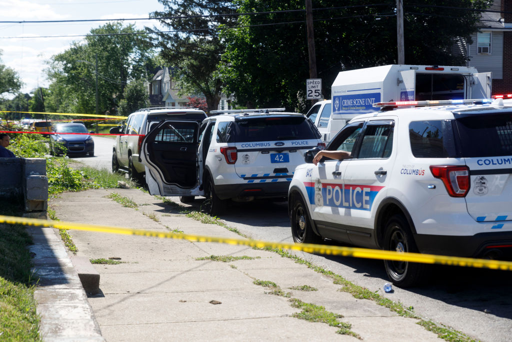 Law enforcement tape cordons off the crime scene where a...