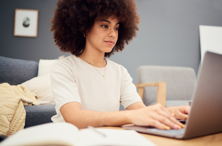 Laptop, planning and business woman or entrepreneur writing notes, idea brainstorming and schedule planner for marketing management. Remote work from home person with internet website copywriting job