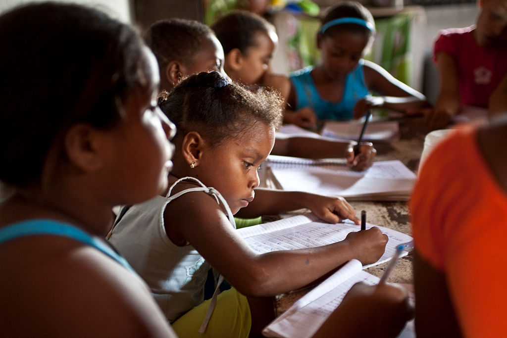 Black children have reinforcement class at home at Agrovila...