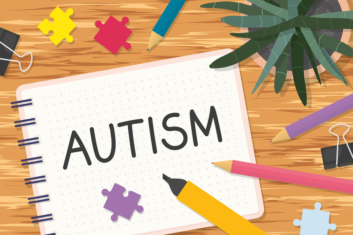 word autism written in notebook, flat lay view