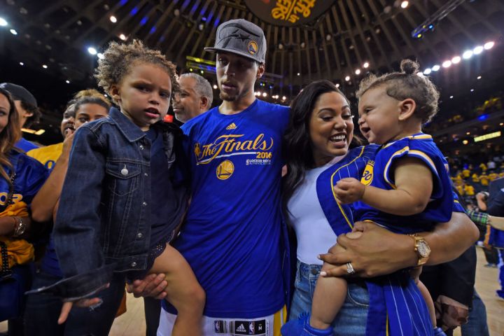 Golden State Warriors' Stephen Curry (30) holds daughter Riley, 3, as his wife Ayesha Curry holds their daughter Ryan Carson Curry, 10 months old, after defeating the Oklahoma City Thunder in Game 7 of the NBA Western Conference finals at Oracle Arena in
