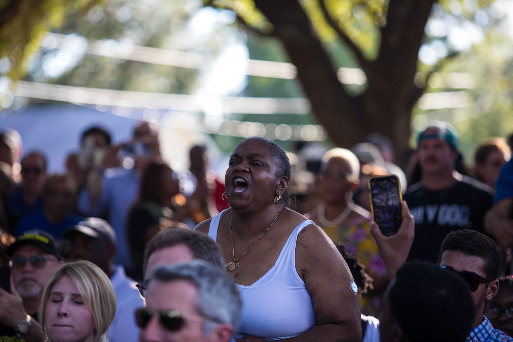 A woman yells as Governor Ron DeSantis