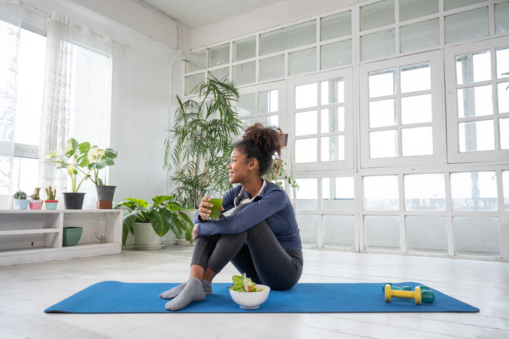 Young women practice yoga at home