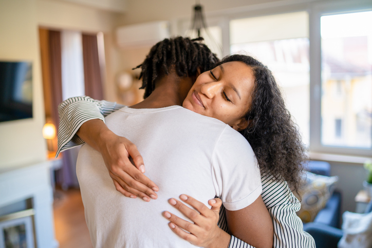 Handsome woman embracing a man