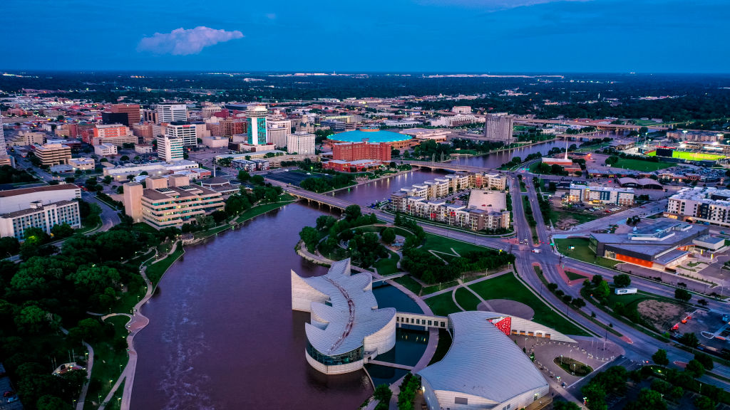 Drone aerial view of downtown Wichita Skyline features Arkansas Rivers, bridges and Exploration Place Science Museum, Kansas
