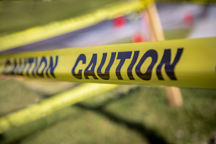 Closeup of caution tape with other strips of caution tape in background