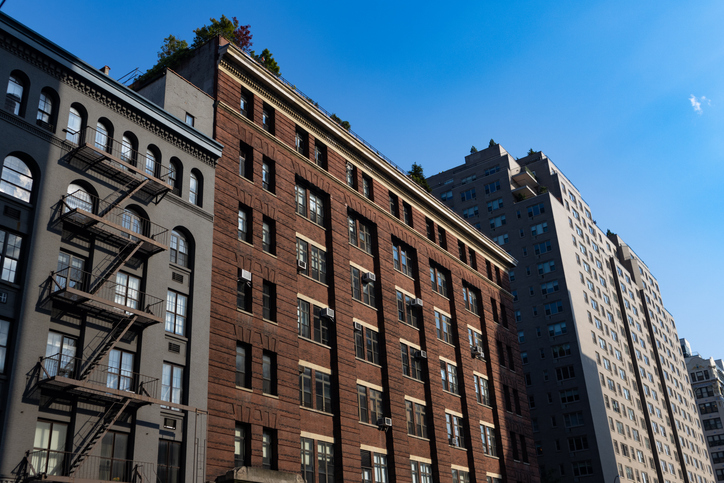 Row of Old Residential Buildings and Skyscrapers in Chelsea New York City