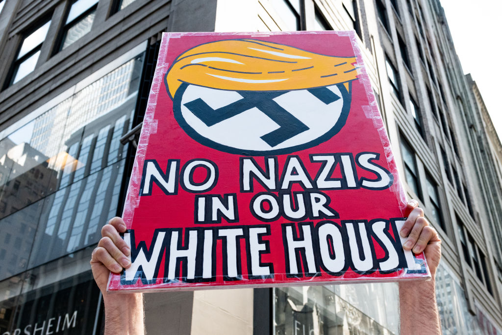 "No Nazis in our White House" sign at a protest rally...