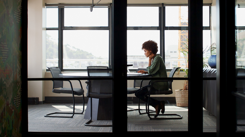 Wide Angle Shot Of Young Businesswoman Working On Laptop At Desk In Her Own Office