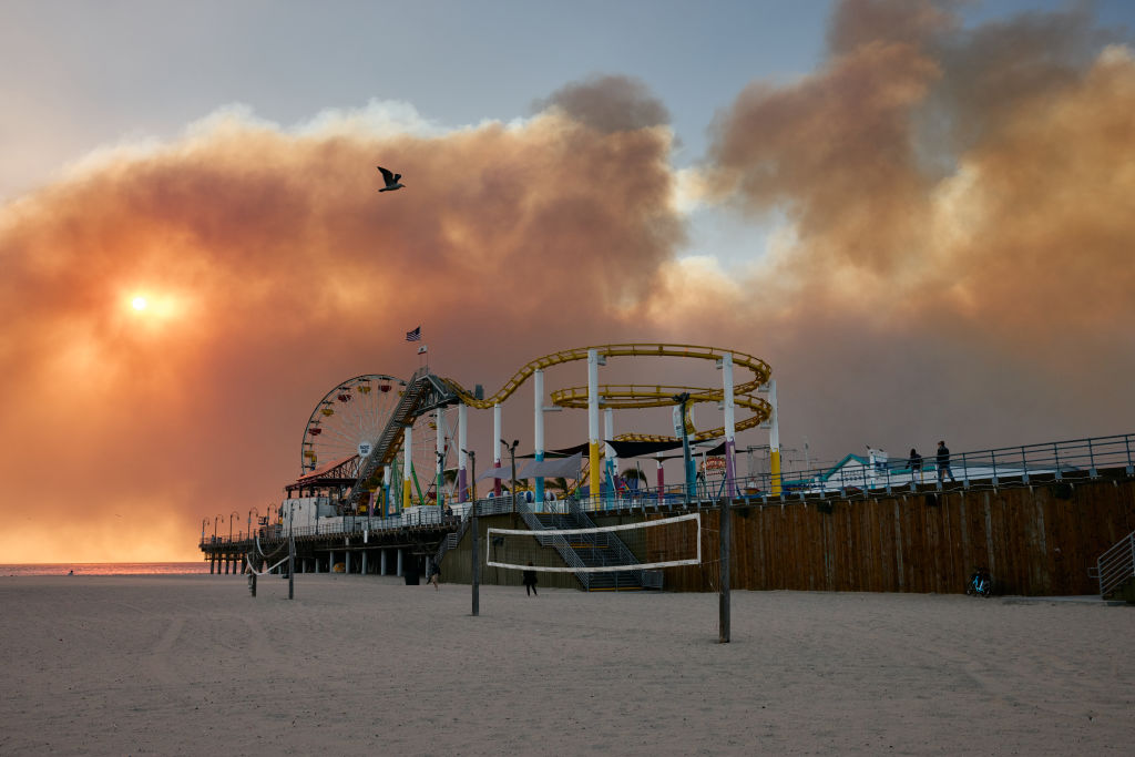 The Palisades fire burns in the distance.