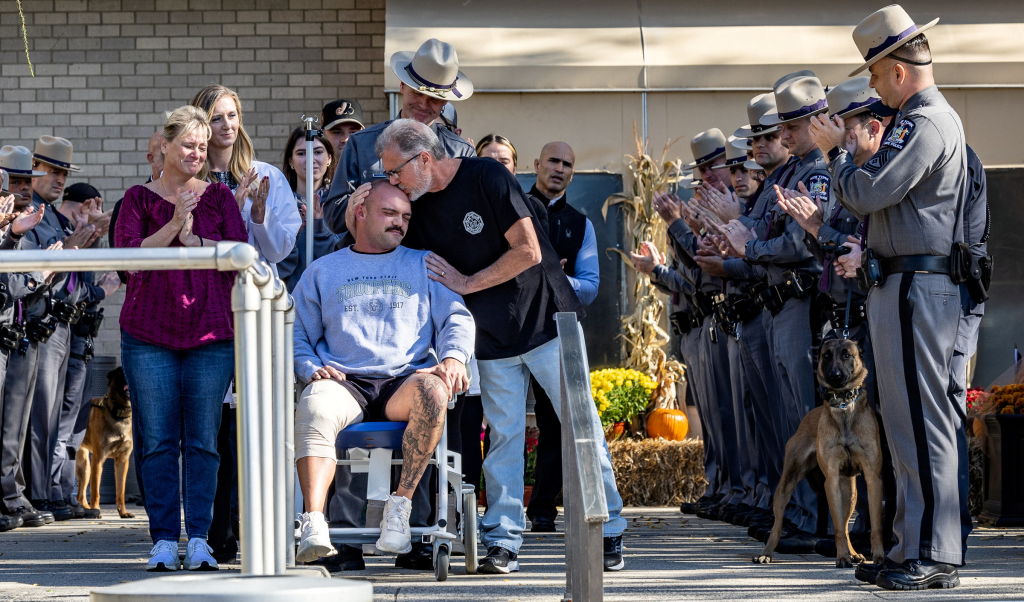 New York State trooper Thomas Mascia leaves Long Island hospital with his parents
