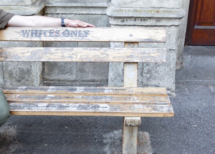 Only white - the inscription on the bench with the hand of white man.