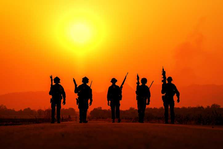 The silhouette of a military soldier with the sun as a Marine Corps for military operations