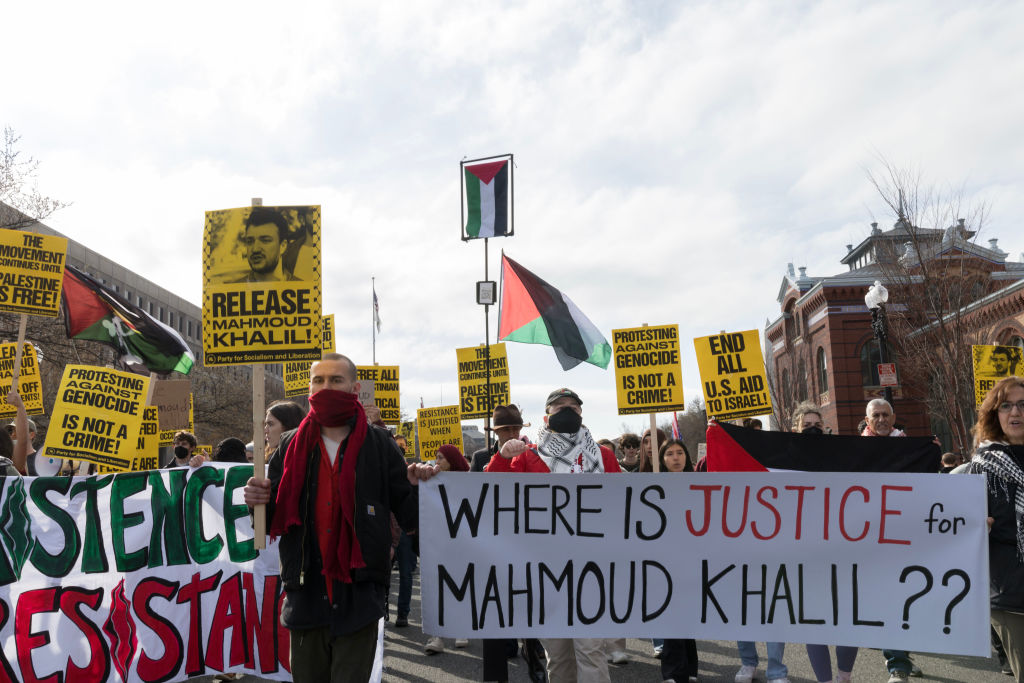 Demonstrators gather outside the U.S. Immigration and...