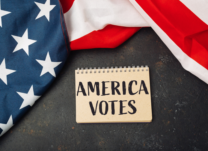 a table with a notebook that says America Votes