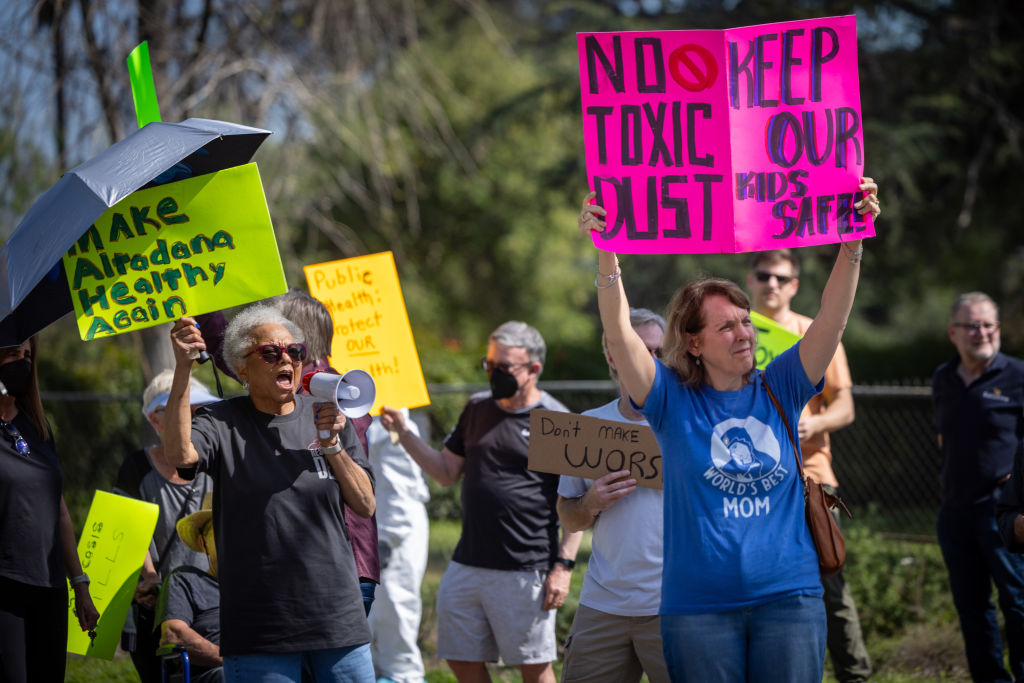 A group of Altadena residents whose homes survived the Eaton fire gather to rally against the concrete recycling operation planned at the Altadena Golf Course...