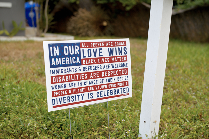 Yard sign promoting equality, love, and diversity with messages against discrimination. Miami, FL, USA