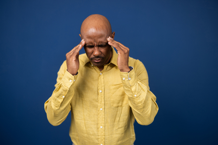 Black man with a headache shot in a studio