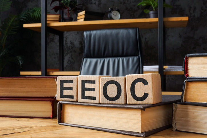 Wooden cubes with abbreviations EEOC Equal Employment Opportunity Commission.
