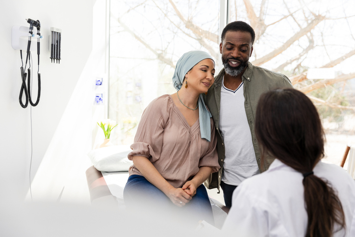 Couple receiving emotional support and healthcare in doctor's office