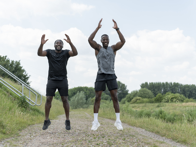 Two men exercising together outdoors