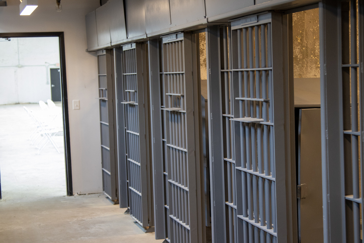 Row of barred jail doors inside historic Lorton Reformatory cellblock, Fairfax County VA