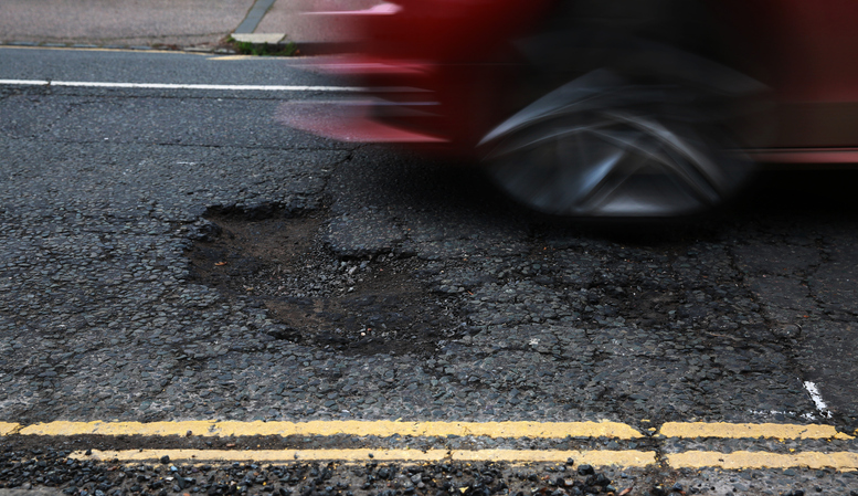 A Pot Hole with moving car