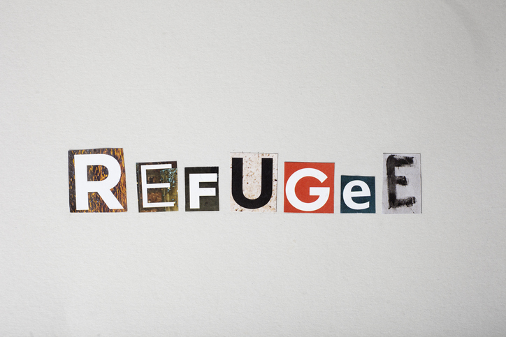The word Refugee is written in a jumbled, torn-up style with magazine letters