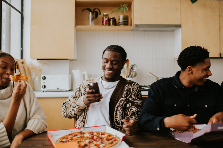 Young people enjoy a delicious pizza