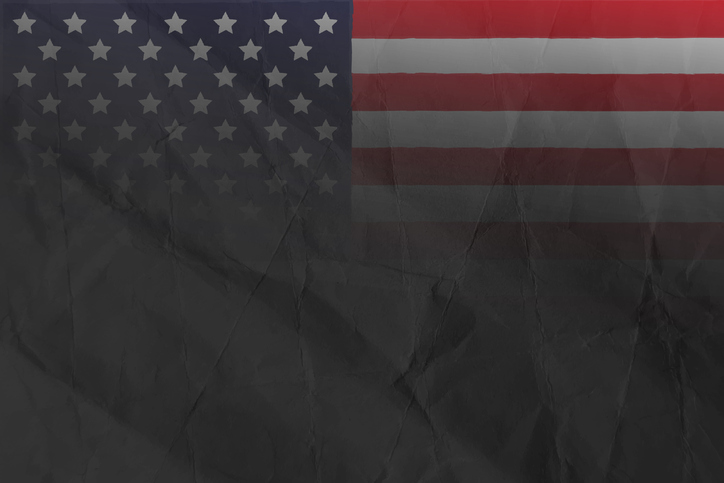 Old weathered faded grunge textured smudged ombre burnt burning damaged ruined USA flag design in dark black brown color at the left edge border of folded uneven horizontal wrinkled crumpled paper texture vector background with folding creases