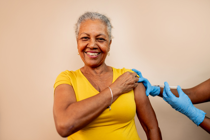 Portrait of a senior woman being vaccinated in a studio shot