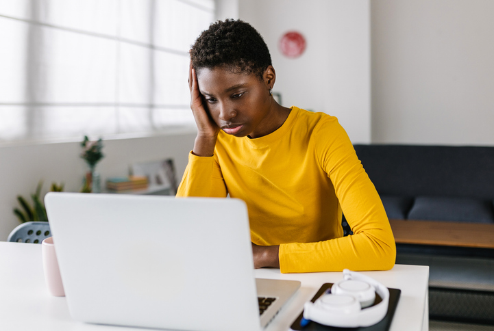 Worried young african woman using laptop at home, Black unemployment, jobs report, money, 