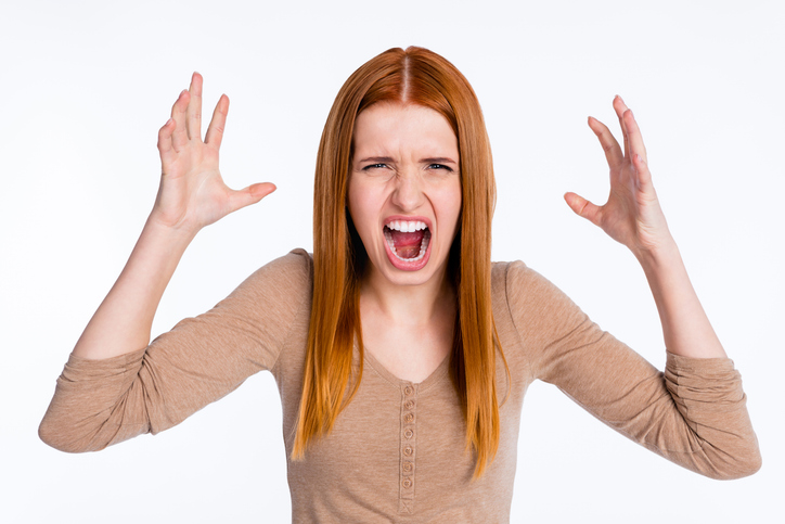 Photo of furious angry ginger lady wear beige shirt rising arms screaming isolated white color background